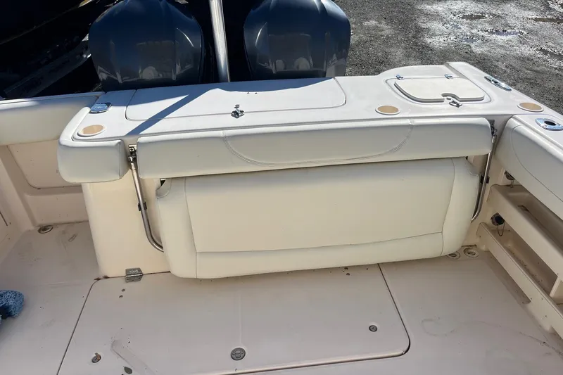 Slide: The Image of 2011 Grady-White Freedom 307 boat interior with seating and dual engines. - 8