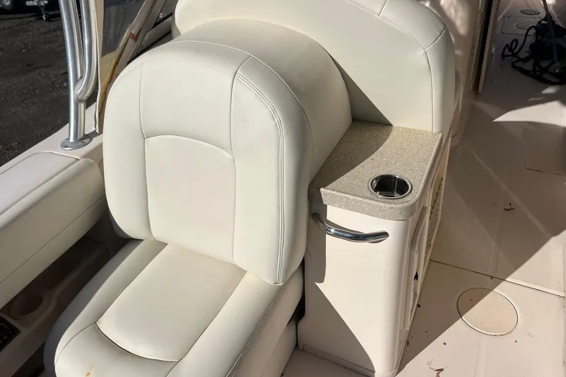 Slide: The Image of 2011 Grady-White Freedom 307 boat interior with white seating and cup holder. - 9