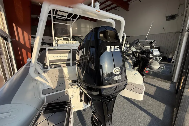Slide: The Image of 2026 Highfield Sport 560 boat with Suzuki 115 outboard motor in showroom. - 4
