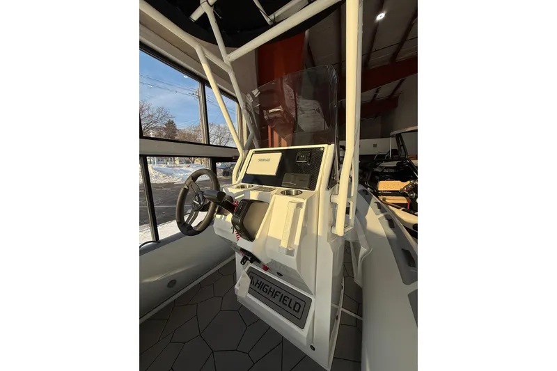 Slide: The Image of 2026 Highfield Sport 560 boat interior with steering wheel and control panel. - 5