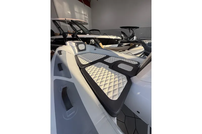 Slide: The Image of 2026 Highfield Sport 560 boat interior with quilted seating in showroom. - 6