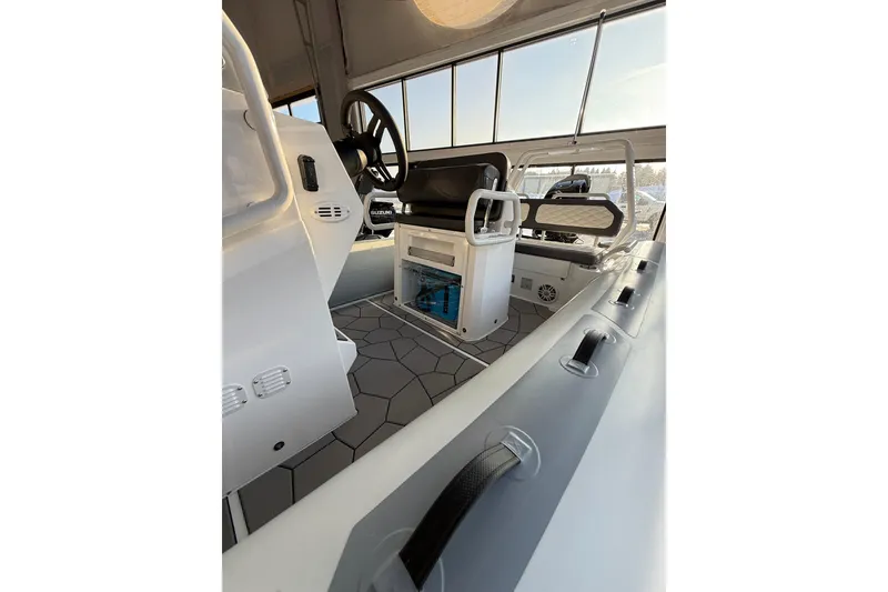 Slide: The Image of 2026 Highfield Sport 560 boat interior with modern steering and seating. - 7