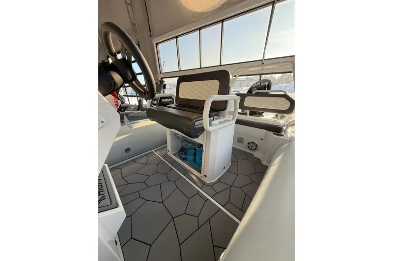 Slide: The Image of Interior of 2026 Highfield Sport 560 boat with modern seating and steering wheel. - 8