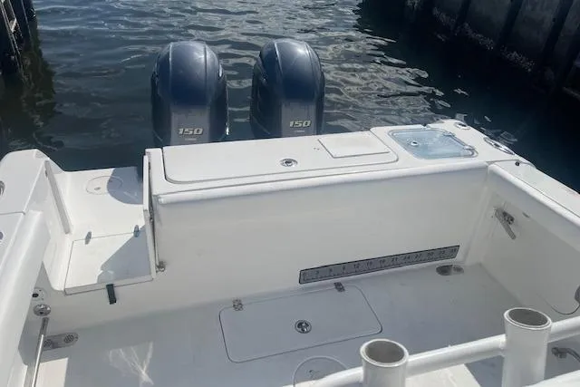 Slide: The Image of 2018 Sea Hunt Gamefish 27 Coffin Box with twin 150 engines, docked by the water. - 12