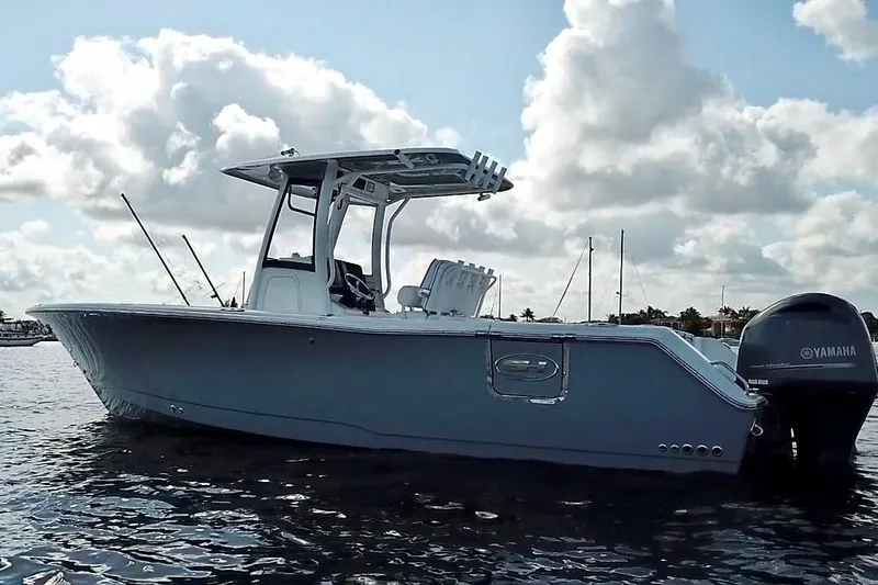 Slide: The Image of 2018 Sea Hunt Gamefish 27 Coffin Box boat on water, under cloudy sky. - 4