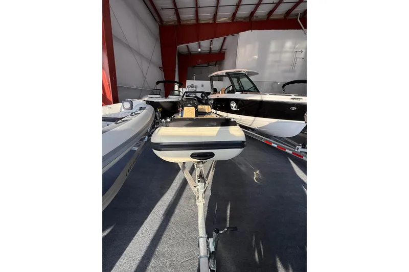 Slide: The Image of 2026 Highfield Sport 420 boat in a showroom, surrounded by other boats. - 15