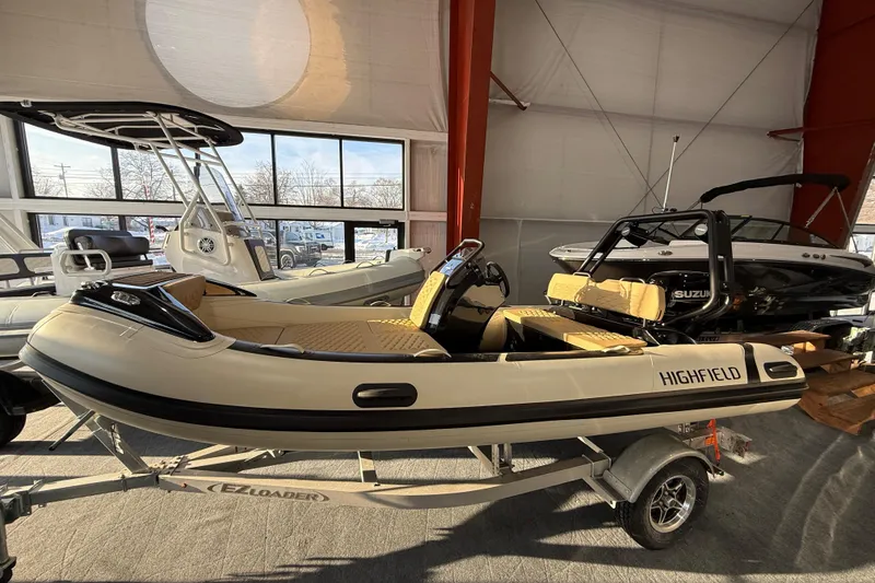 The Image of 2026 Highfield Sport 420 boat displayed indoors on a trailer. - 5