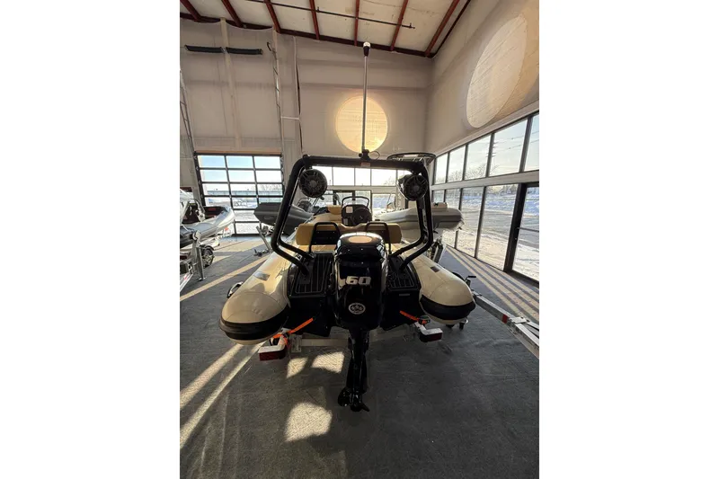 Slide: The Image of 2026 Highfield Sport 420 boat in showroom, rear view with motor and seating. - 9