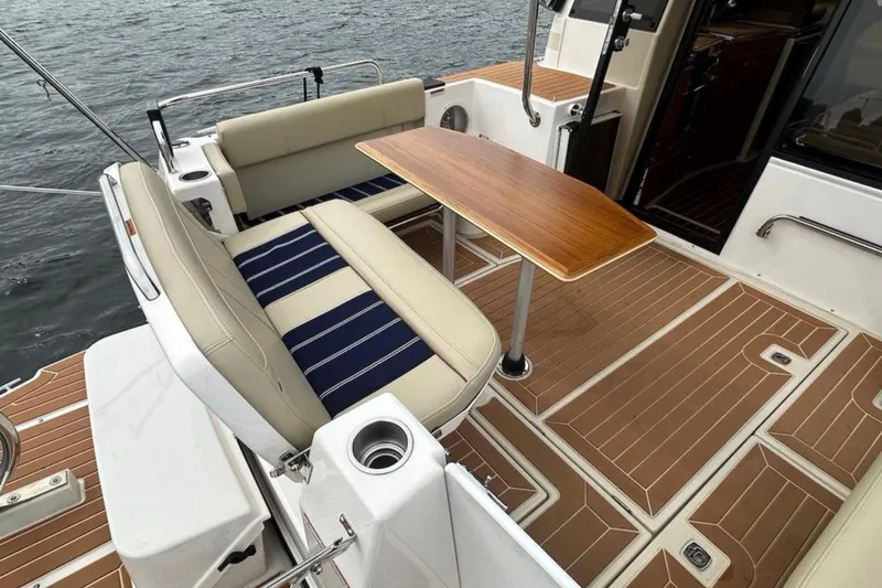 Slide: The Image of 2021 Ranger Tugs R-29 S docked at a serene marina under clear blue skies. - 2