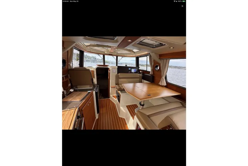 Slide: The Image of 2021 Ranger Tugs R-29 S cabin interior with cozy bed and porthole windows. - 22