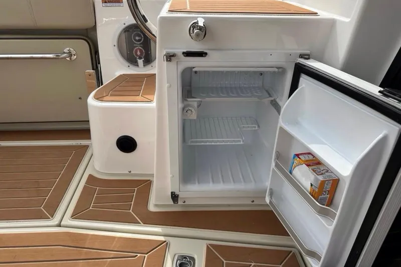 Slide: The Image of 2021 Ranger Tugs R-29 S boat interior with canopy and seating in a garage. - 6