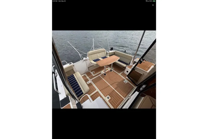 Slide: The Image of 2021 Ranger Tugs R-29 S boat interior with open mini fridge and wooden flooring. - 9