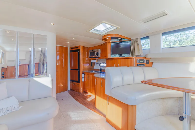 Slide: The Image of Interior of 2006 Carver 36 Mariner yacht with modern kitchen and seating area. - 12