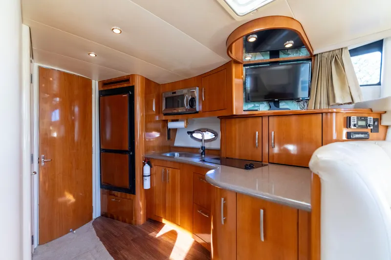 Slide: The Image of Interior of 2006 Carver 36 Mariner yacht with modern kitchen and entertainment area. - 14