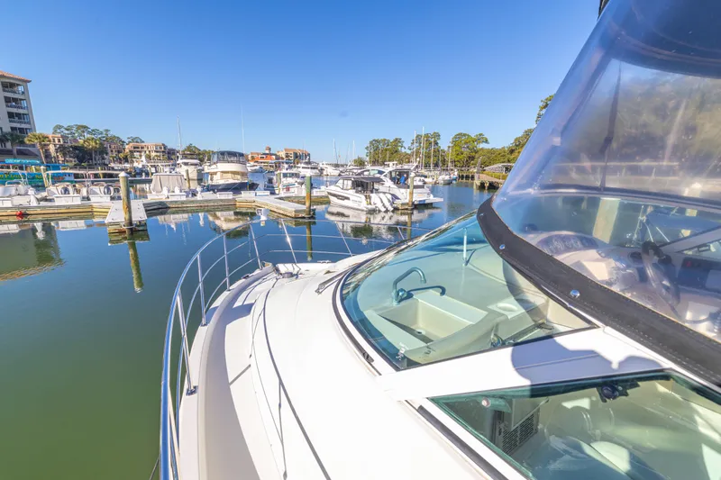 Slide: The Image of 2006 Carver 36 Mariner yacht docked in a sunny marina. - 21