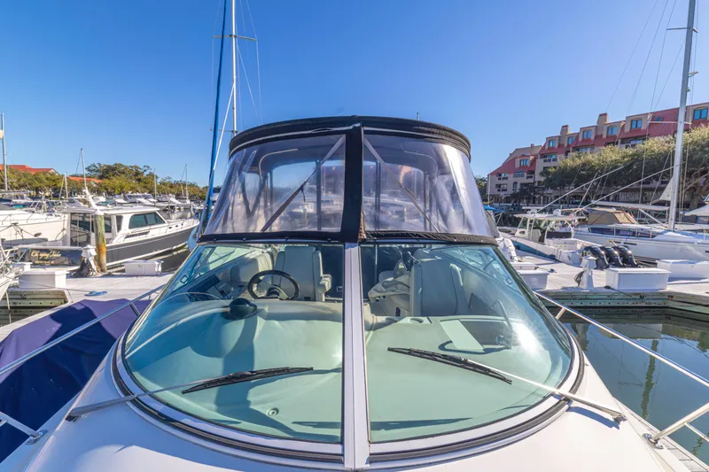Slide: The Image of 2006 Carver 36 Mariner yacht docked at a marina under clear blue skies. - 22