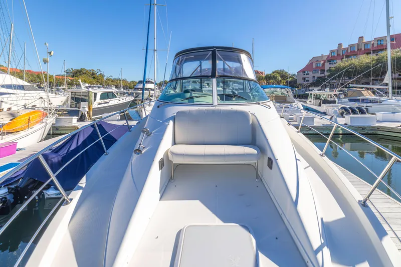 Slide: The Image of 2006 Carver 36 Mariner yacht docked at a marina under clear blue skies. - 23