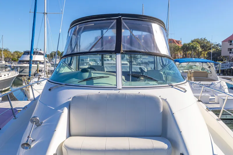 Slide: The Image of 2006 Carver 36 Mariner yacht docked at marina under clear blue sky. - 24