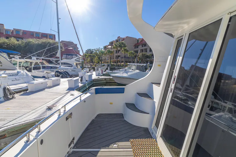 Slide: The Image of 2006 Carver 36 Mariner yacht docked at marina under sunny sky. - 25