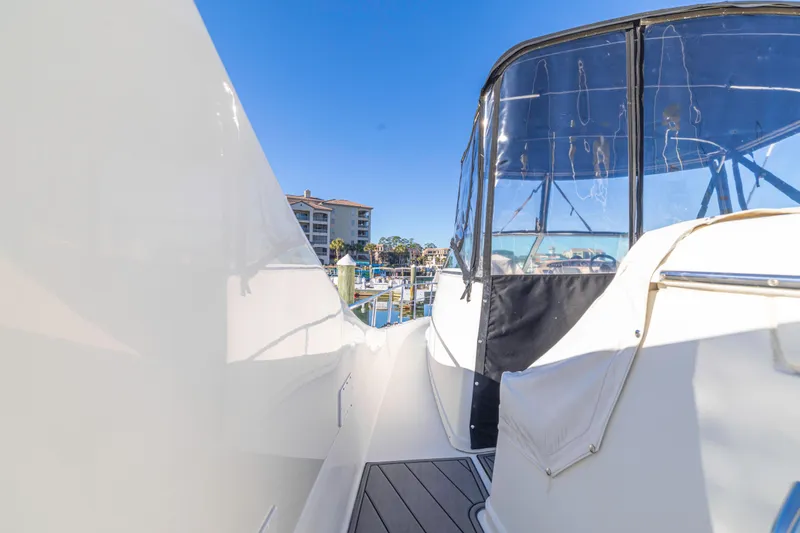 Slide: The Image of 2006 Carver 36 Mariner yacht docked at marina, clear blue sky background. - 27