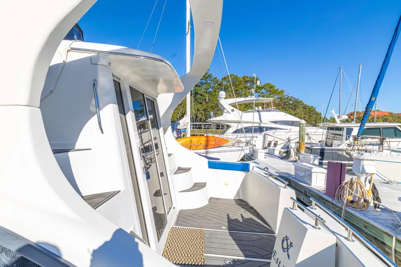Slide: The Image of 2006 Carver 36 Mariner yacht docked at marina under clear blue sky. - 3