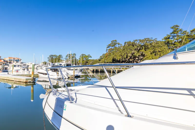 Slide: The Image of 2006 Carver 36 Mariner yacht docked in a serene marina under clear blue skies. - 4