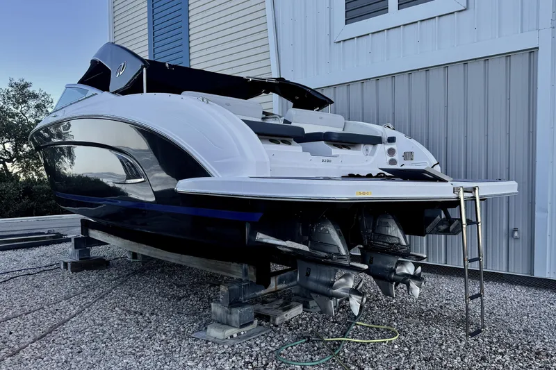 Slide: The Image of 2014 Regal 3200 Bowrider boat on dry dock, rear view with dual engines. - 11
