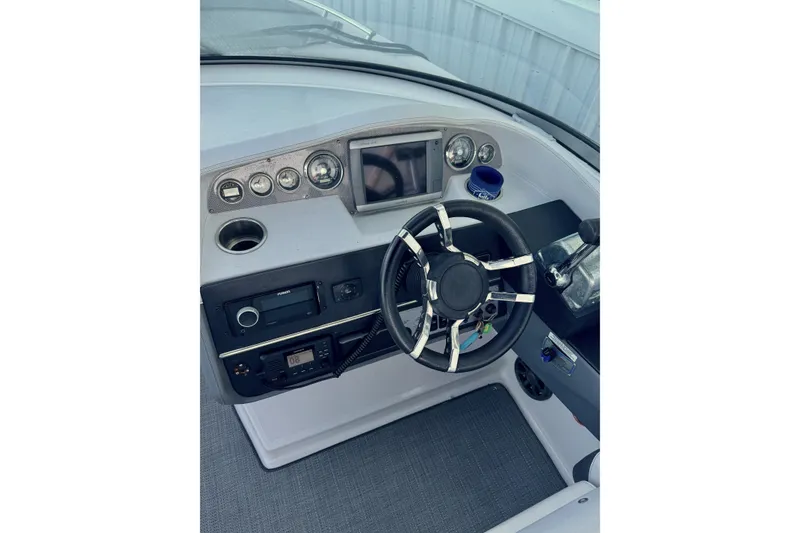 Slide: The Image of 2014 Regal 3200 Bowrider dashboard with steering wheel and control panel. - 15
