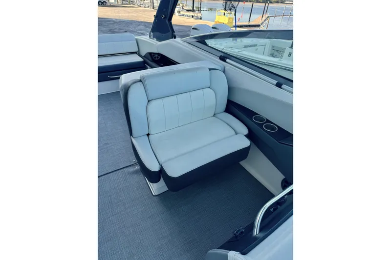 Slide: The Image of 2014 Regal 3200 Bowrider interior with cushioned seating and cup holders. - 16