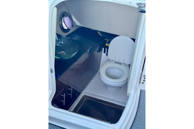 Slide: The Image of 2014 Regal 3200 Bowrider boat bathroom with toilet and glass sink. - 17