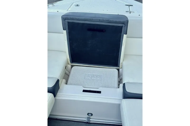 Slide: The Image of 2014 Regal 3200 Bowrider interior with built-in cooler storage. - 18