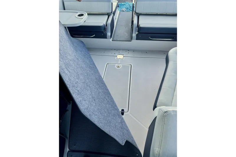 Slide: The Image of 2014 Regal 3200 Bowrider interior with seating and storage compartments. - 28