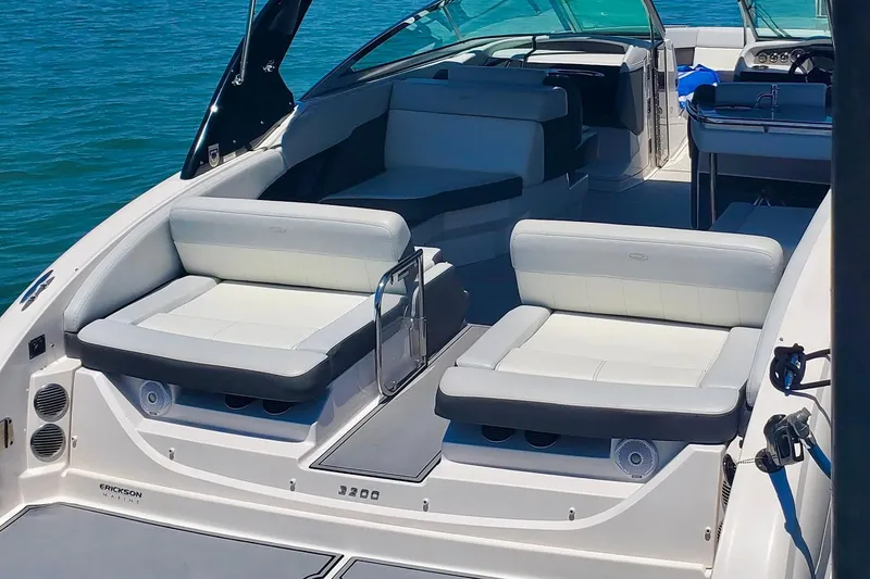 Slide: The Image of 2014 Regal 3200 Bowrider boat interior with spacious seating on clear water. - 7