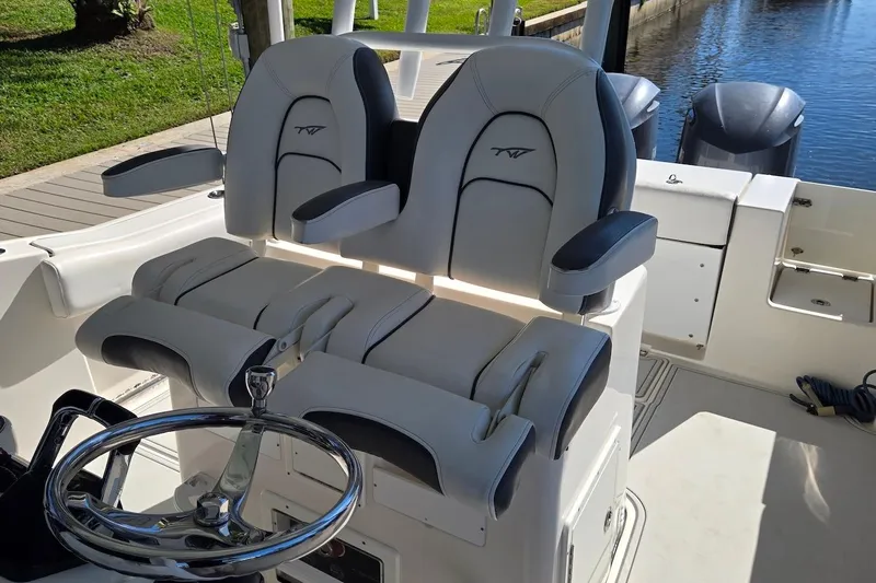 Slide: The Image of 2015 Tidewater 280 CC Adventure boat helm with dual seats and steering wheel. - 11