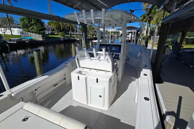 Slide: The Image of 2015 Tidewater 280 CC Adventure boat docked, featuring spacious deck and modern controls. - 15