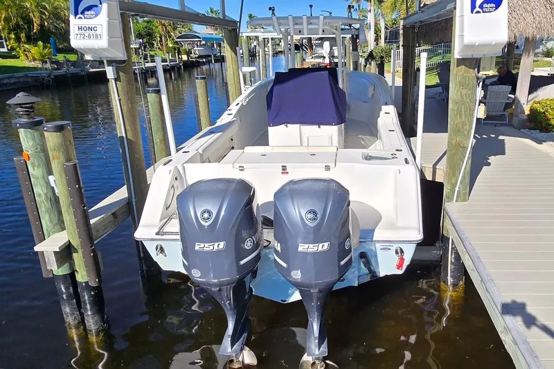 Slide: The Image of 2015 Tidewater 280 CC Adventure boat with dual Yamaha 250 engines docked by a pier. - 18