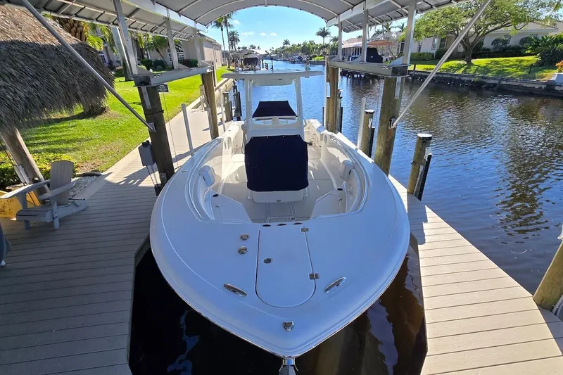 Slide: The Image of 2015 Tidewater 280 CC Adventure boat docked in a scenic canal setting. - 19