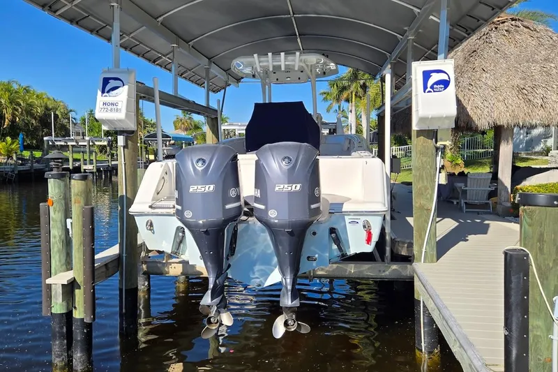 Slide: The Image of 2015 Tidewater 280 CC Adventure boat with twin Yamaha 250 engines at dock. - 23