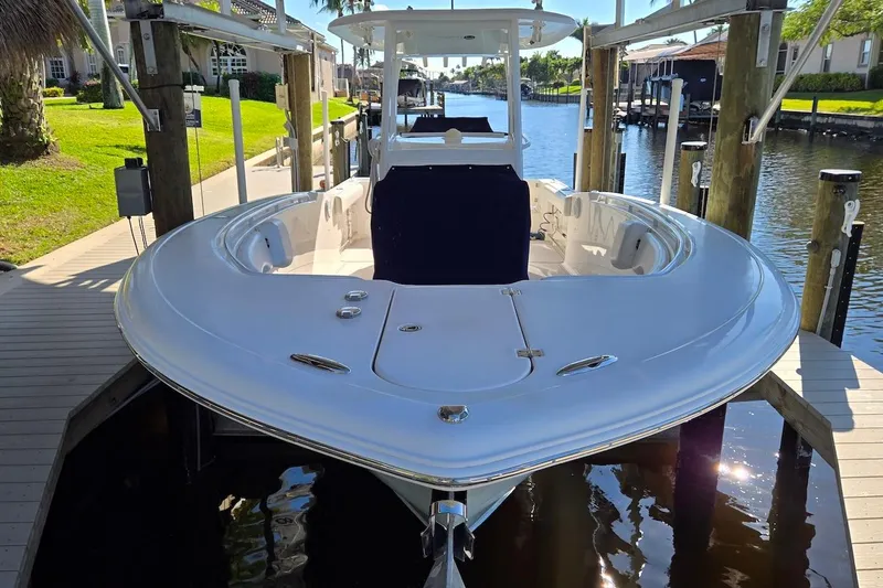 Slide: The Image of 2015 Tidewater 280 CC Adventure boat docked in a sunny canal setting. - 25