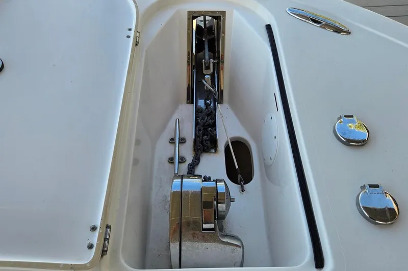 Slide: The Image of Anchor compartment of 2015 Tidewater 280 CC Adventure boat, featuring chain and winch. - 26