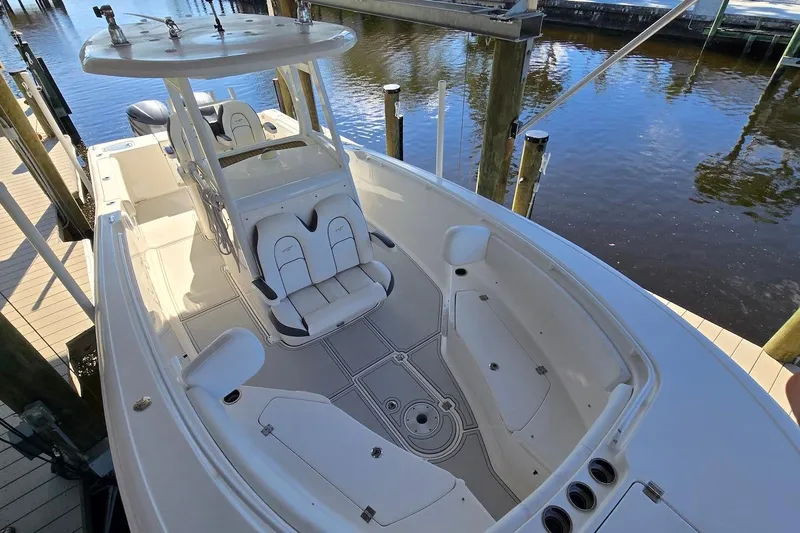 Slide: The Image of 2015 Tidewater 280 CC Adventure boat docked, featuring spacious seating and sleek design. - 4