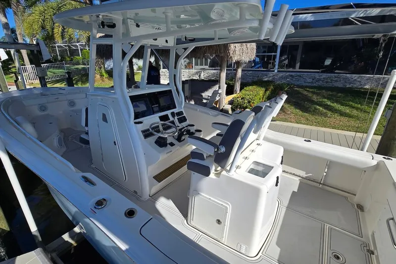 Slide: The Image of 2015 Tidewater 280 CC Adventure boat interior with helm and seating area. - 5