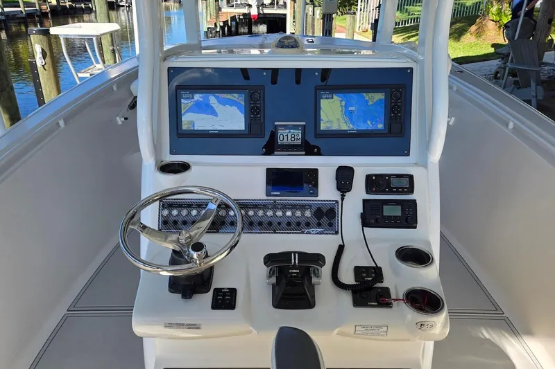 Slide: The Image of 2015 Tidewater 280 CC Adventure boat dashboard with navigation screens and controls. - 8
