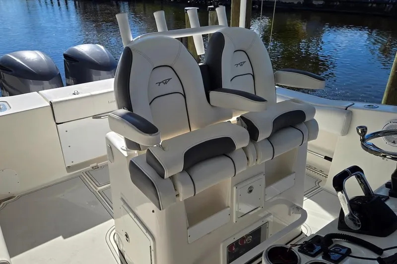 Slide: The Image of 2015 Tidewater 280 CC Adventure boat interior with dual captain's chairs and controls. - 9