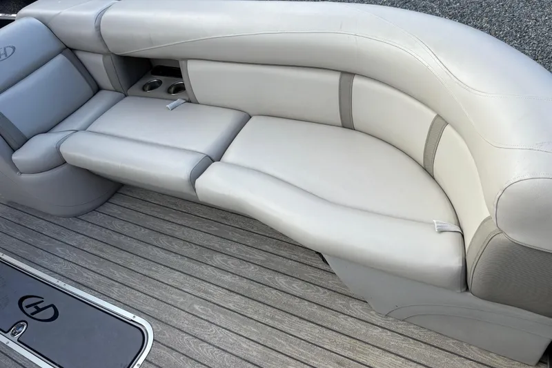 Slide: The Image of 2020 Harris Cruiser 250 boat interior with plush seating and cup holders. - 29