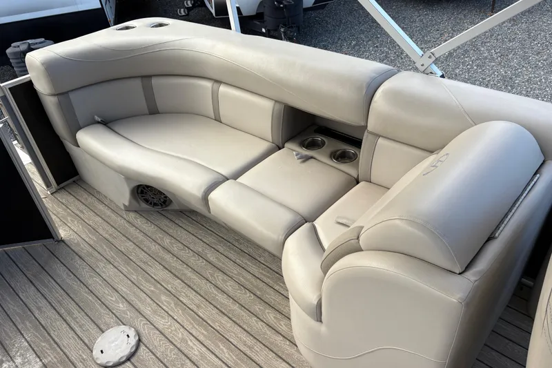 Slide: The Image of 2020 Harris Cruiser 250 boat interior with beige seating and cup holders. - 30