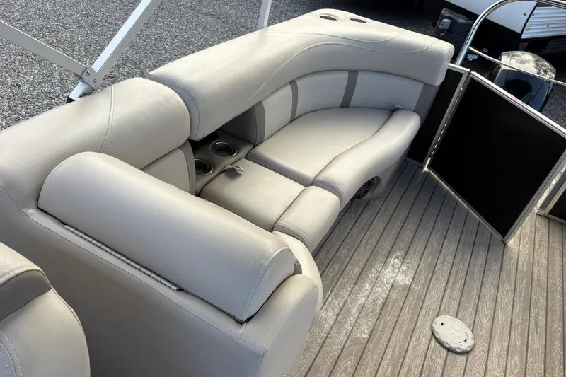 Slide: The Image of 2020 Harris Cruiser 250 boat interior with gray seating and cup holders. - 31