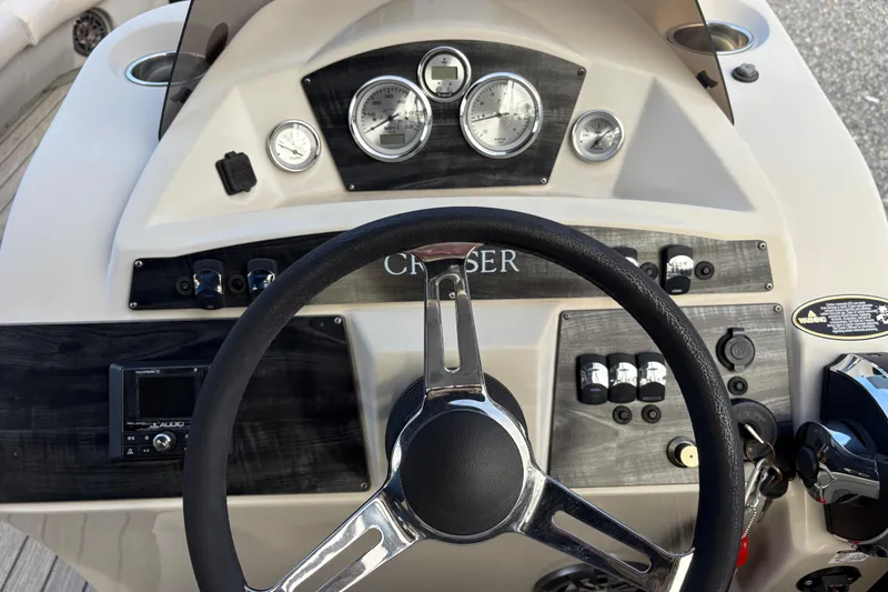 Slide: The Image of 2020 Harris Cruiser 250 dashboard with steering wheel and control panel. - 32