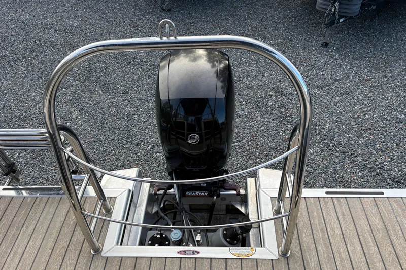 Slide: The Image of 2020 Harris Cruiser 250 boat engine with stainless steel railing on a wooden deck. - 37