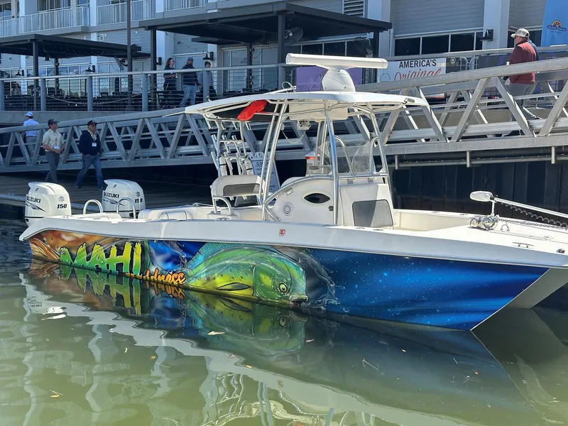 The Image of 2017 Twin Vee 26 GF boat with vibrant Mahi Mahi artwork docked at a marina. - 1